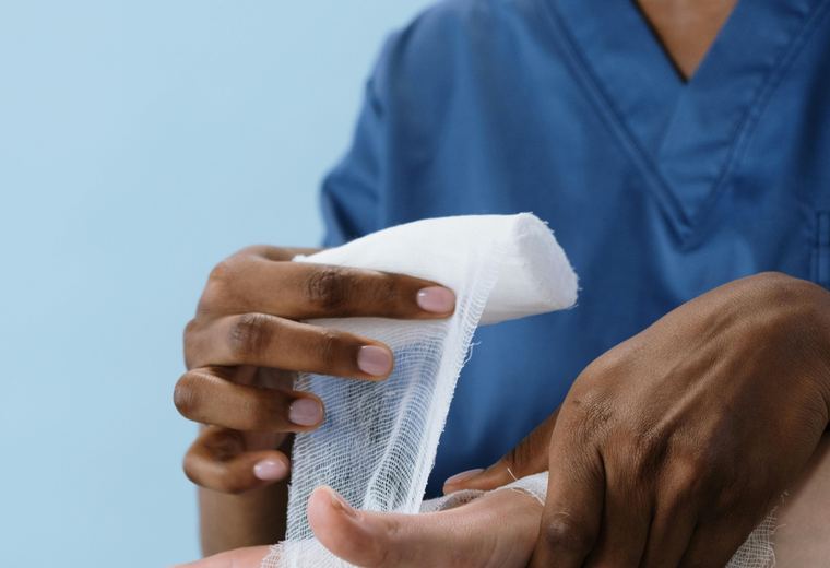 Clinician wrapping an injured hand