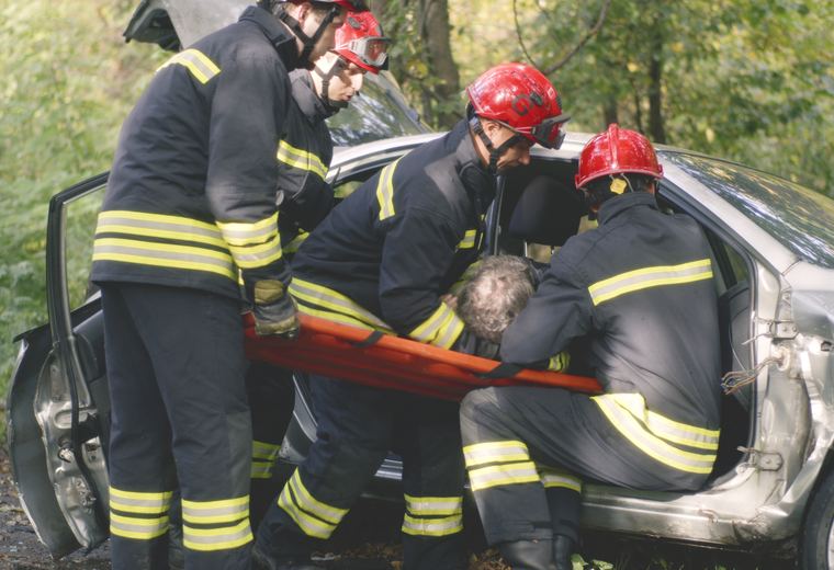 Emergency crews assisting a car accident victim